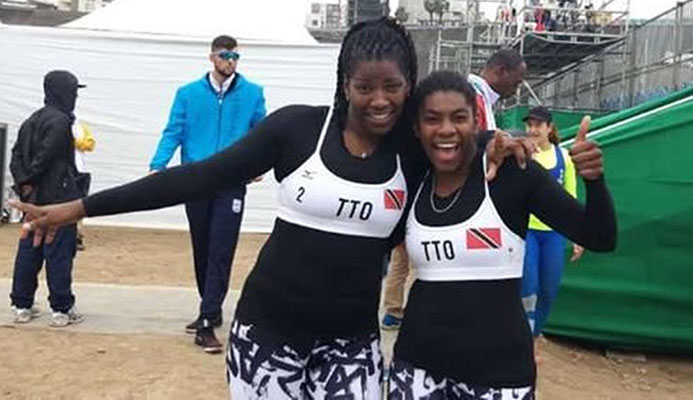 T&T beach volleyballers Rheeza Grant, left, and Malika Davidson are all smiles after defeating USVI, 2-0, yesterday at the Pan American Games in Lima, Peru. 