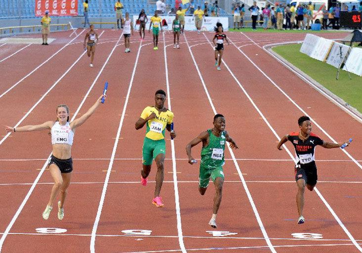 FAST FINISH: Nigeria’s Sunday Okon (42.68), second from right, finishes just ahead of  England’s Thea Brown (42.71) and T&T’s Jamario Russell (42.77), right, during the exciting  4 x100m Mixed Relay finals yesterday at the Trinbago 2023 Commonwealth Youth Games at the Hasely Crawford Stadium. Team T&T copped bronze in the unique event that featured teams of two males and two females exchanging batons. —Photo: ROBERT TAYLOR (Image obtained at trinidadexpress.com)