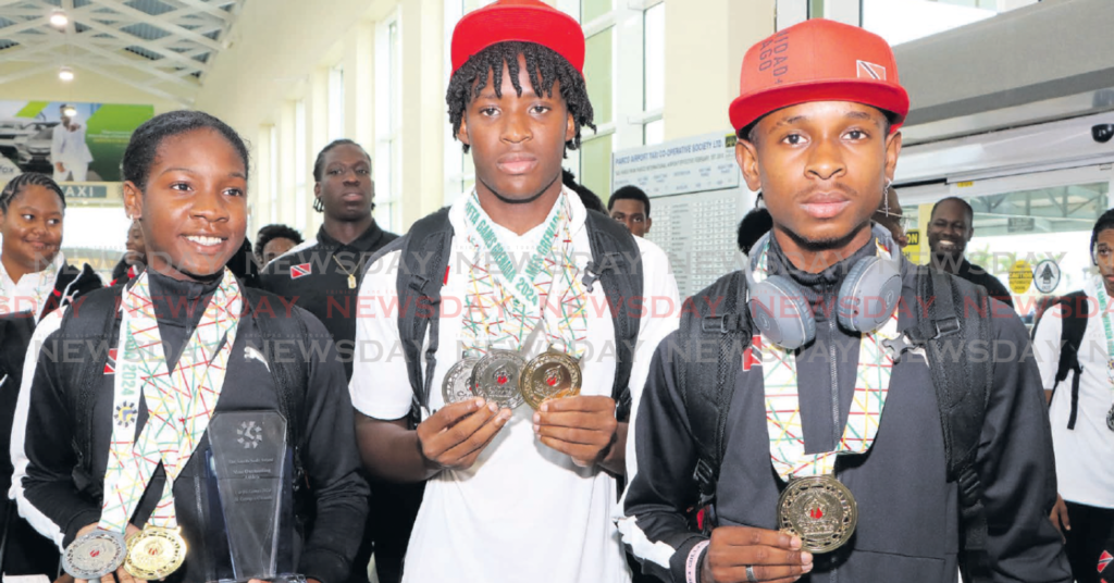 CHAMPIONS: Carifta athletes (from left) Janae De Gannes, Kadeem Chinapoo and Tafari Waldron show their silverware at the Piarco International Airport on Tuesday. Photo by Angelo Marcelle (Image obtained at newsday.co.tt)