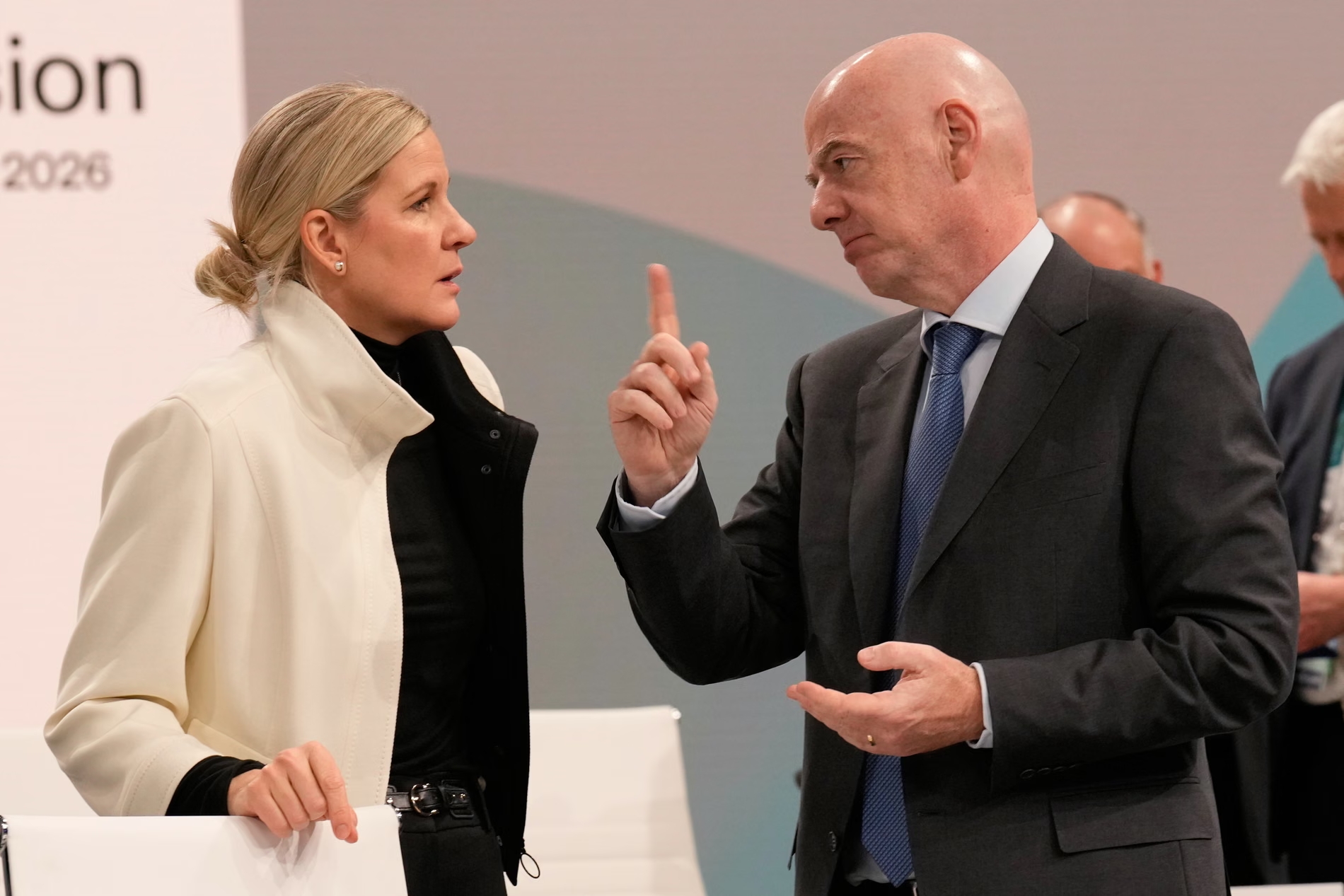 The IOC president, Kirsty Coventry, speaks to the Fifa president and IOC member Gianni Infantino in Milan. Photograph: Luca Bruno/AP (Image obtained at theguardian.com)
